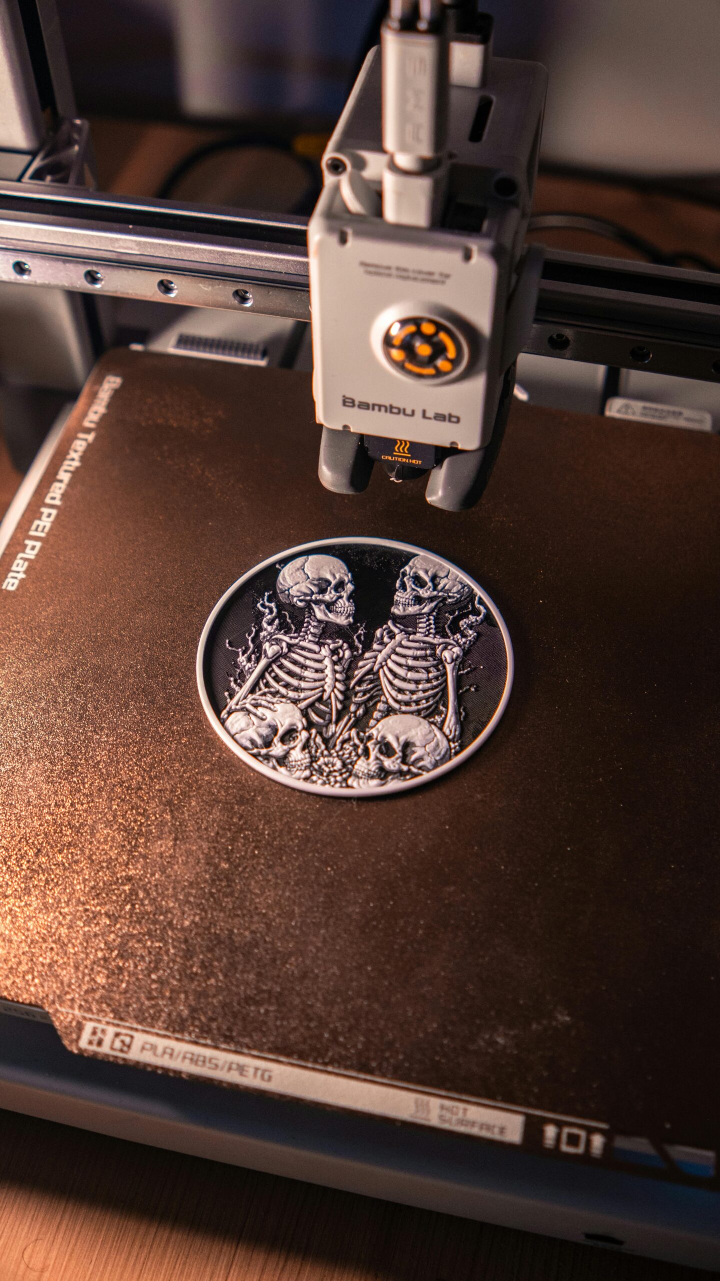 Home Close-up of an intricate 3D printed skeleton artwork being created on a 3D printer, showcasing digital craftsmanship.